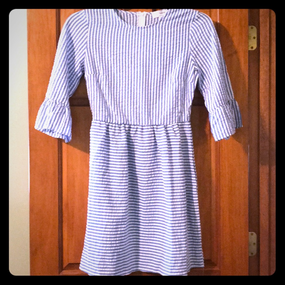 Blue and white seersucker dress with bell sleeves.